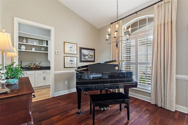 misc room with dark hardwood / wood-style flooring, a notable chandelier, and vaulted ceiling