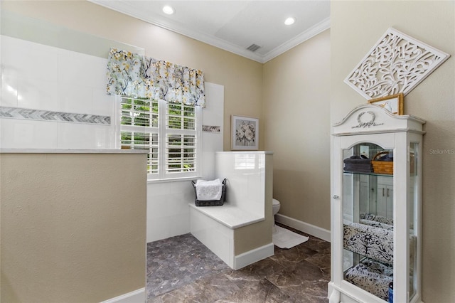 bathroom featuring crown molding and toilet