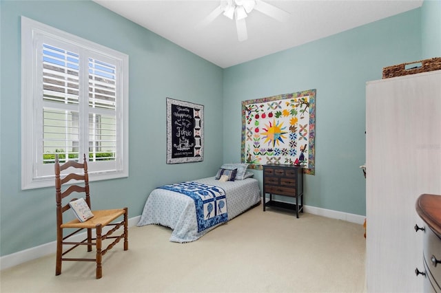 bedroom featuring ceiling fan and light colored carpet