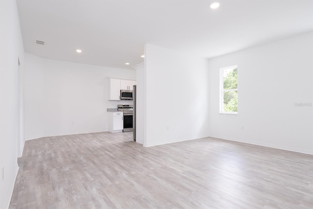 unfurnished living room featuring light hardwood / wood-style floors