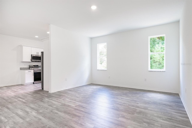 unfurnished living room with light hardwood / wood-style floors