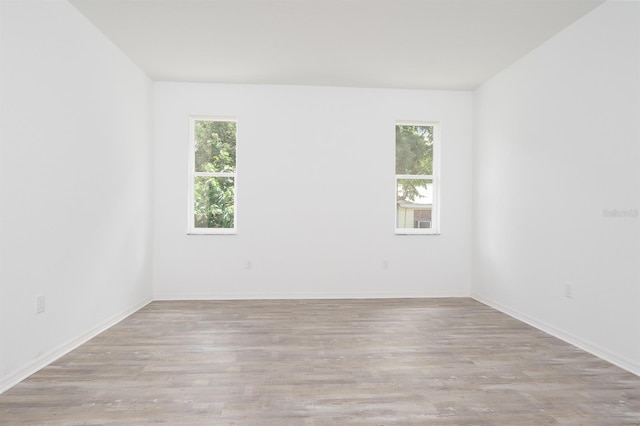 empty room with light hardwood / wood-style flooring