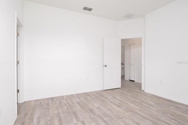 unfurnished room with light wood-type flooring