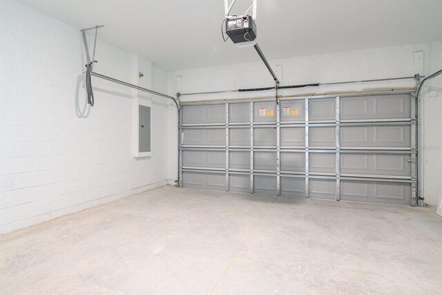 garage with a garage door opener and electric panel