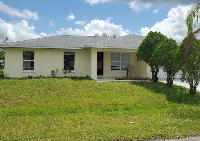 single story home featuring a garage and a front lawn