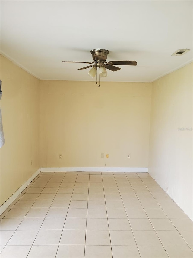 empty room with light tile patterned floors and ceiling fan