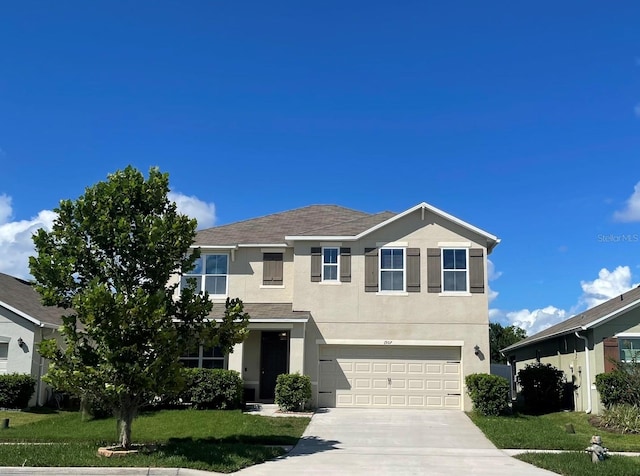 view of front of property featuring a front yard and a garage