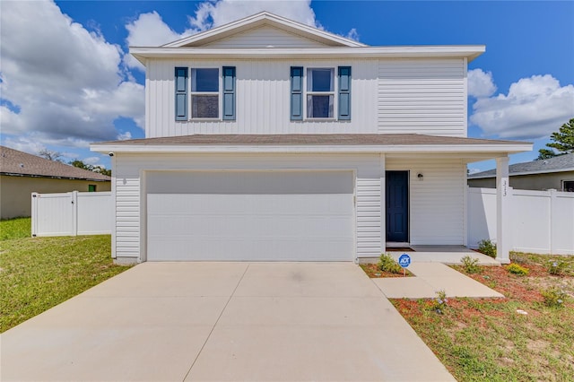 front of property featuring a garage and a front lawn