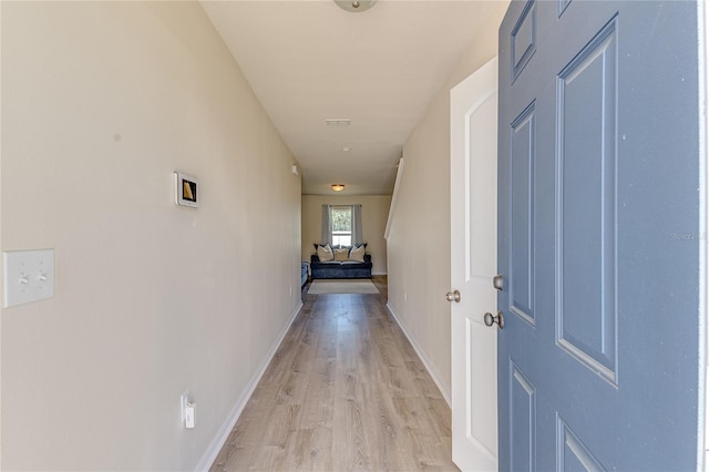 hallway with light wood-type flooring