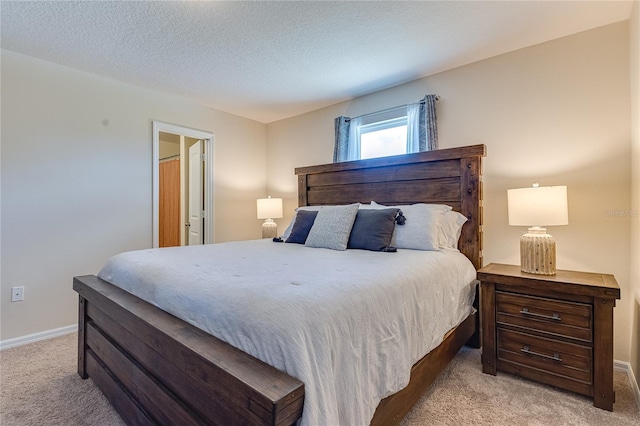 carpeted bedroom featuring a textured ceiling