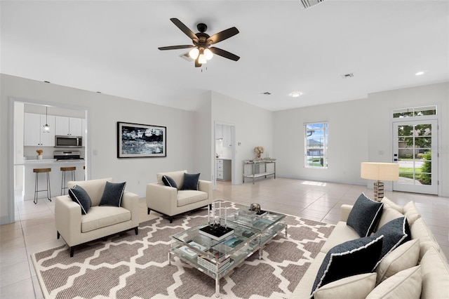 tiled living room with ceiling fan