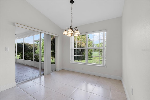 empty room with vaulted ceiling, an inviting chandelier, and light tile patterned floors