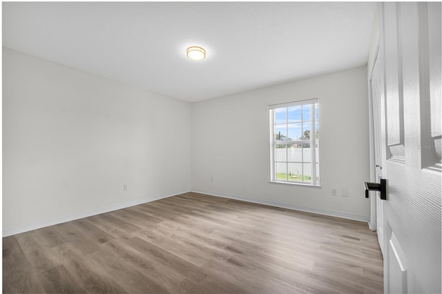 unfurnished room with light hardwood / wood-style flooring