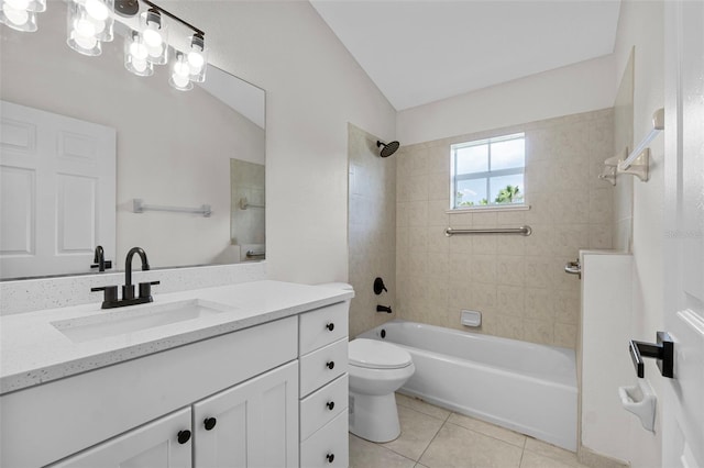 full bathroom featuring toilet, tile patterned floors, vanity, tiled shower / bath combo, and lofted ceiling