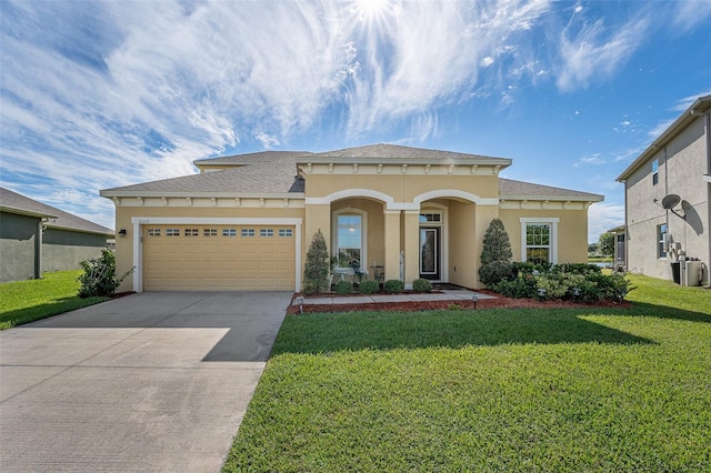 view of front of house with a front yard and a garage