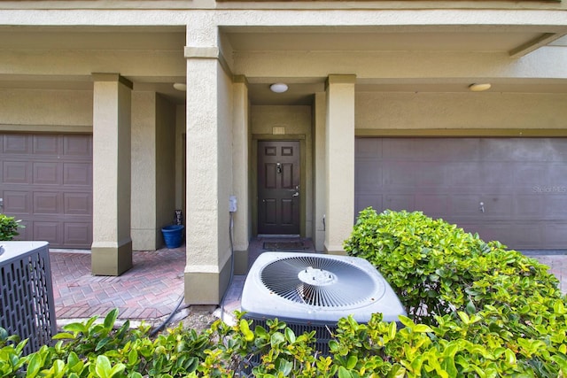 entrance to property with central AC and a garage