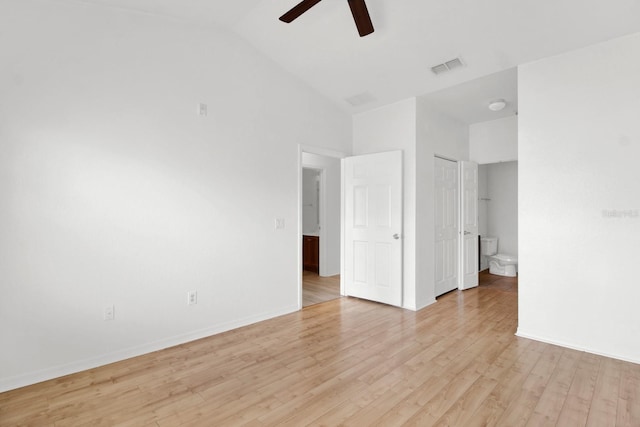 interior space featuring ceiling fan, high vaulted ceiling, light hardwood / wood-style flooring, and ensuite bath