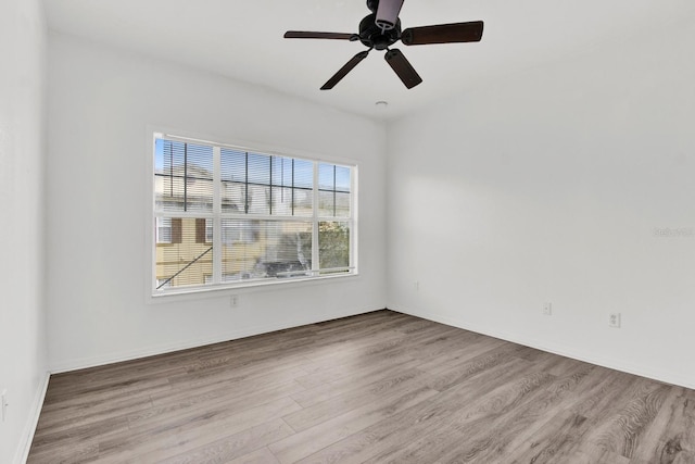 empty room with ceiling fan and light wood-type flooring