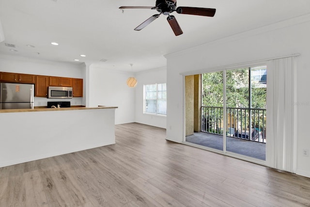 unfurnished living room featuring crown molding, light wood-type flooring, and ceiling fan