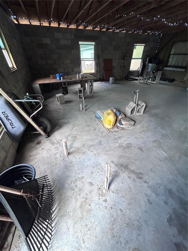 misc room featuring a wealth of natural light and concrete block wall