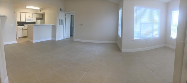 unfurnished living room with light tile patterned floors