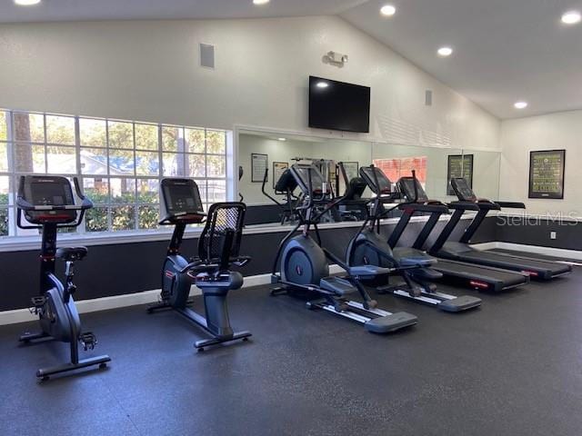 workout area featuring high vaulted ceiling