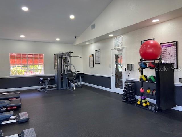 gym featuring lofted ceiling