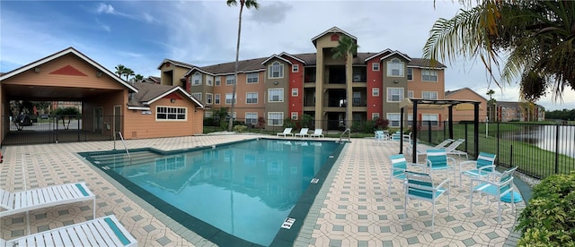 view of pool with a pergola and a patio