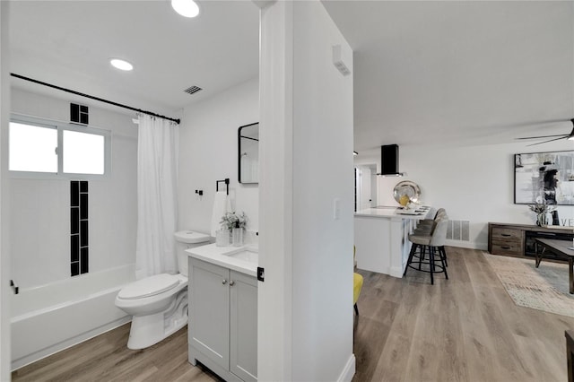 full bathroom with vanity, toilet, shower / bath combo with shower curtain, and hardwood / wood-style flooring