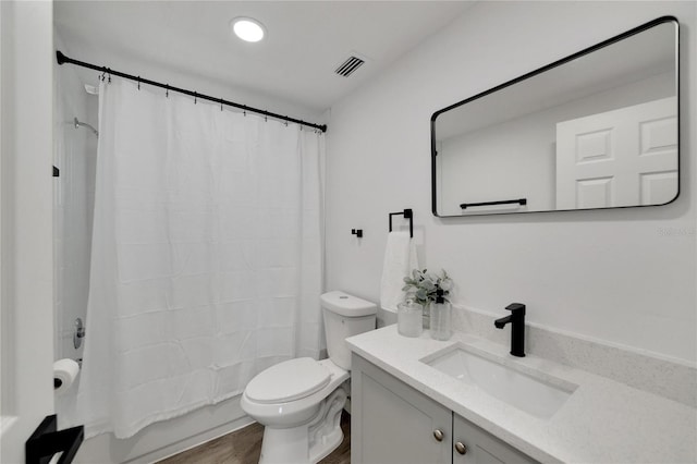 full bathroom with shower / bath combination with curtain, wood-type flooring, toilet, and vanity