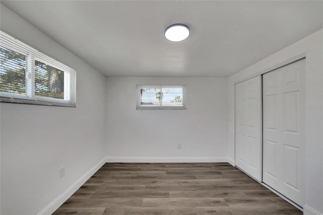 unfurnished bedroom featuring a closet and hardwood / wood-style floors