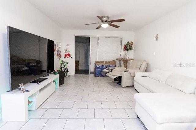 tiled living room featuring ceiling fan