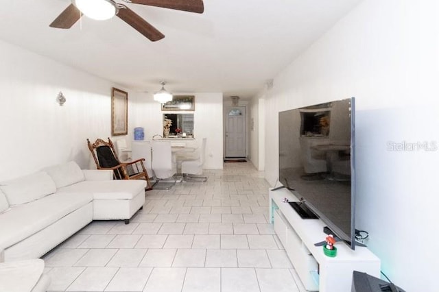 living room with ceiling fan and light tile patterned flooring