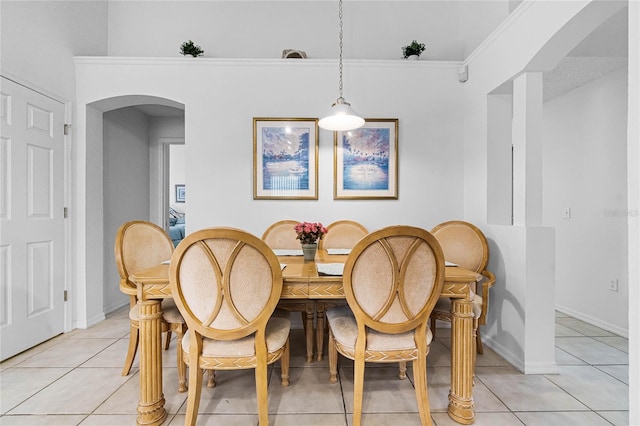 dining area featuring crown molding and light tile patterned flooring