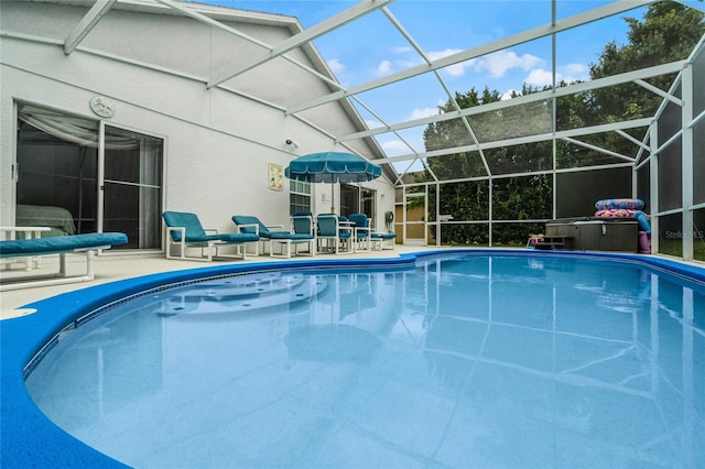 view of pool with a patio and a lanai