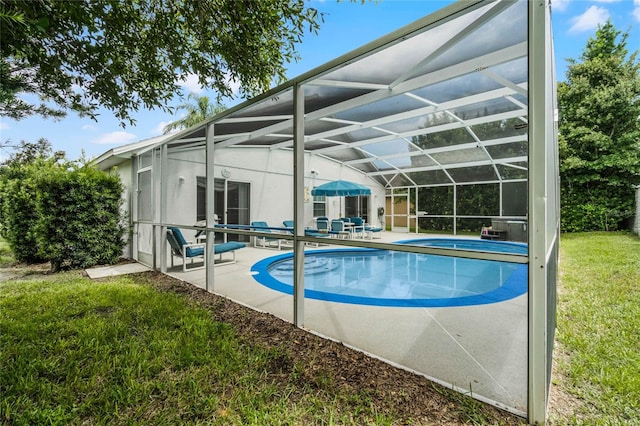 view of pool featuring a patio area, a lawn, and a lanai