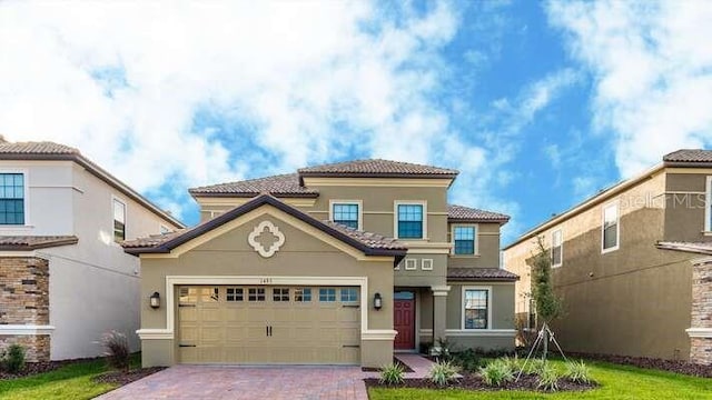 1495 Rolling Fairways Dr, Davenport, FL 33896 - mediterranean / spanish-style home featuring stucco siding, decorative driveway, and a tiled roof
