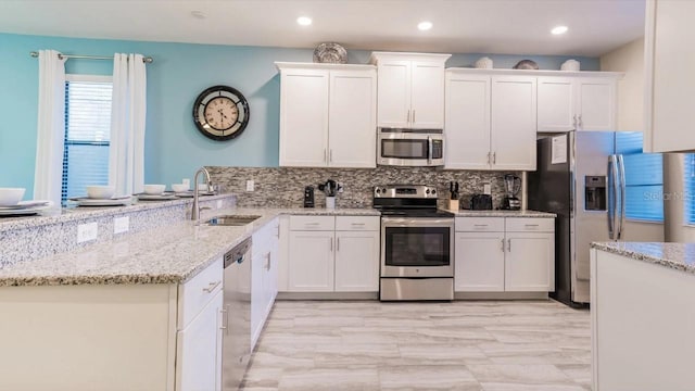 kitchen with white cabinets, stainless steel appliances, and sink