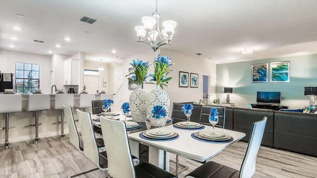 dining area featuring a chandelier and light hardwood / wood-style floors