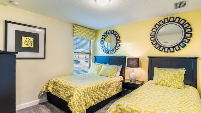 bedroom with a textured ceiling and carpet