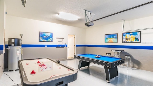 game room with a textured ceiling and water heater