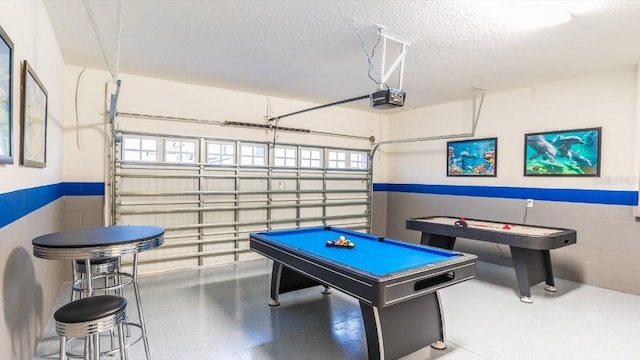 game room featuring pool table and a textured ceiling