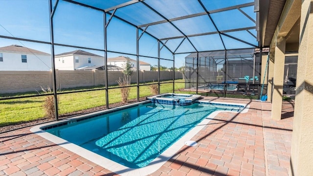 view of swimming pool featuring glass enclosure, an in ground hot tub, and a patio area