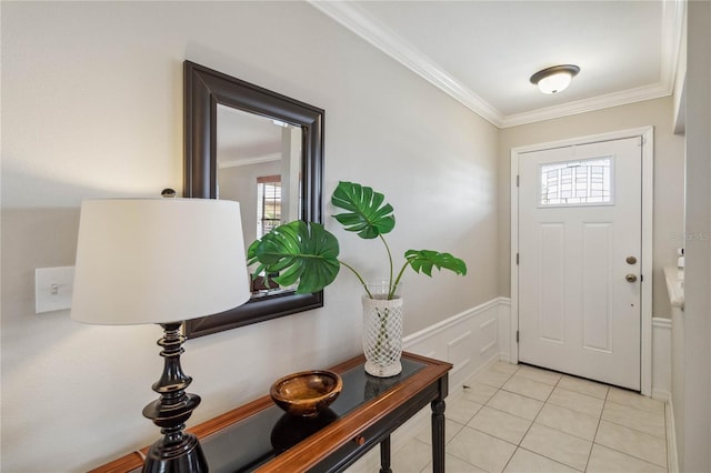 tiled foyer entrance featuring ornamental molding and plenty of natural light