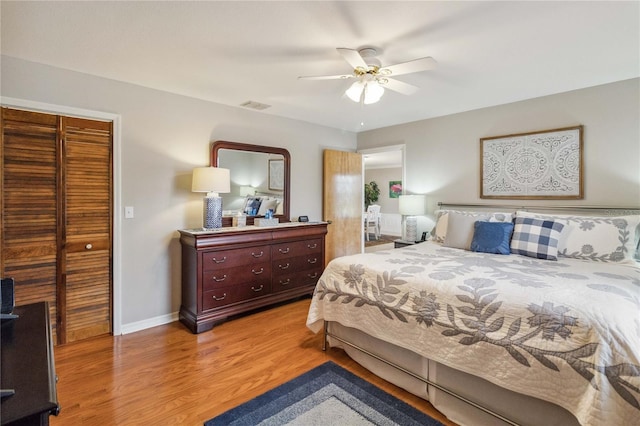 bedroom with light wood-type flooring, a closet, and ceiling fan