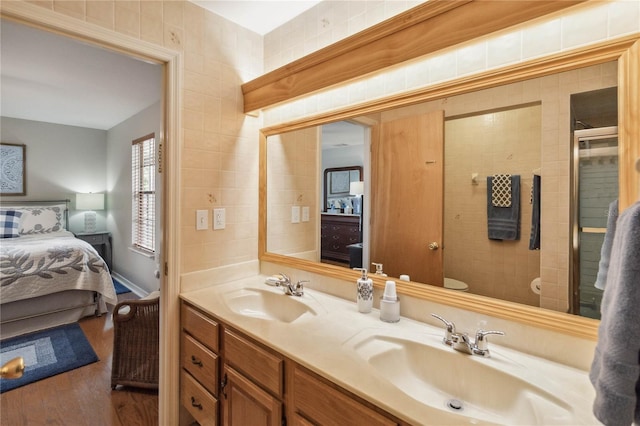 bathroom featuring a shower with door, vanity, toilet, and wood-type flooring