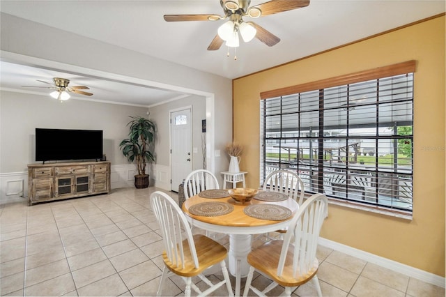 dining area featuring ceiling fan, light tile patterned floors, and crown molding