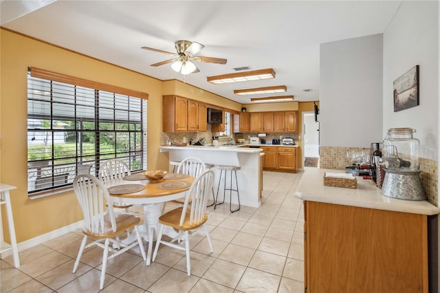 tiled dining room with ceiling fan