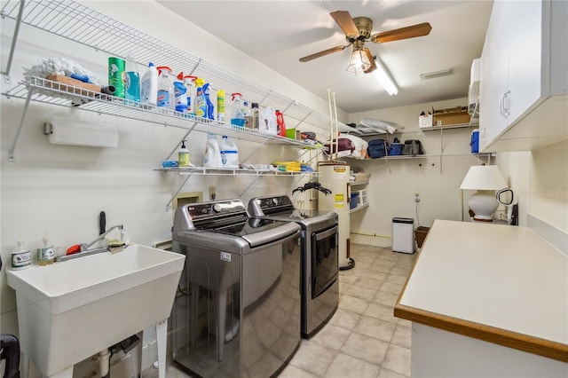 clothes washing area featuring cabinets, independent washer and dryer, sink, electric water heater, and ceiling fan