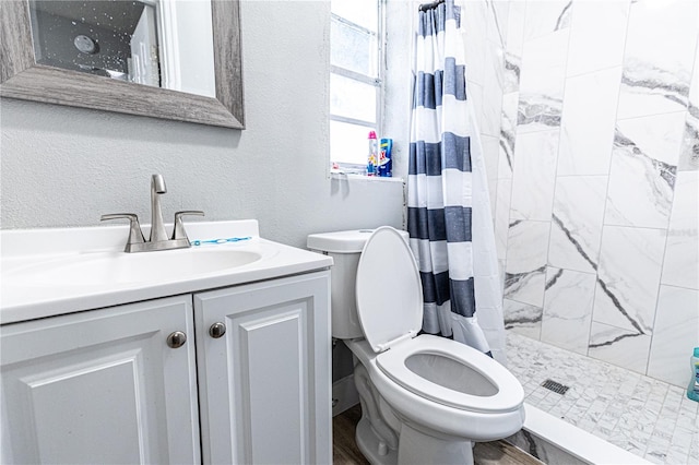 bathroom featuring a shower with curtain, toilet, hardwood / wood-style flooring, and vanity